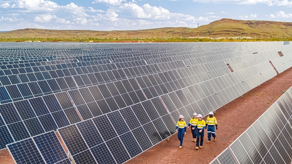 Rio Tinto employees walking through a solar farm