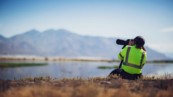 Landscape shot of a camera person taking a picture of lake