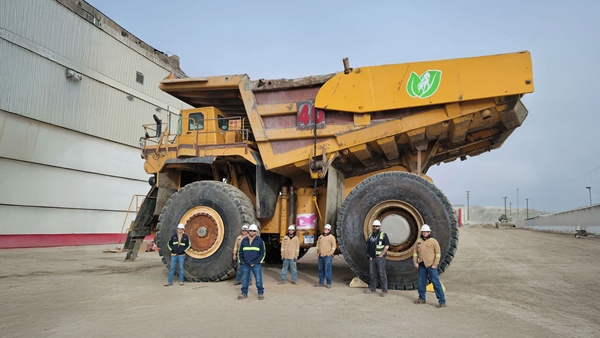 Mining staffs standing in front of massive haul truck at our Boron operation in the US.