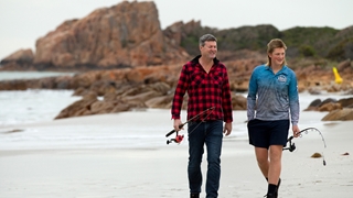 Two people walking on a beach
