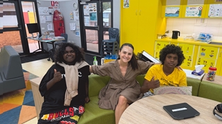 Gove TCD Facilitator sitting together with 2 young students