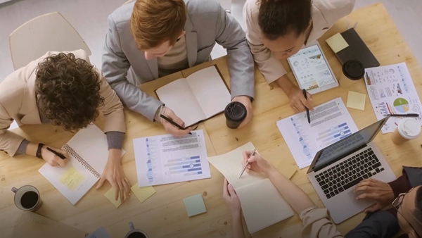 A group of people discussing about work in office