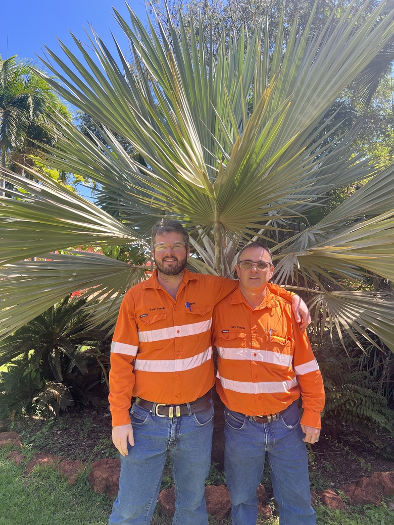 Mark and Randle wearing a safety vest and glass posing for the camera