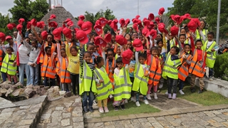A group of children raising Rio Tinto hat