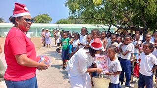 lady distributing toys to children in occasion of Christmas holiday