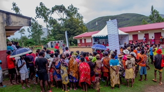 A group of people listening to an announcement