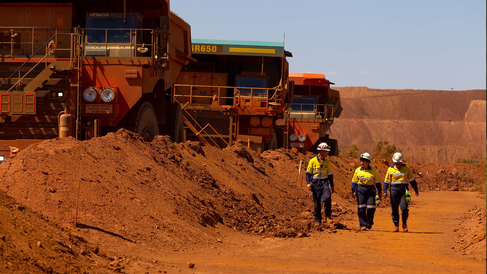 Employees safely walking next to HME at West Angelas Mine