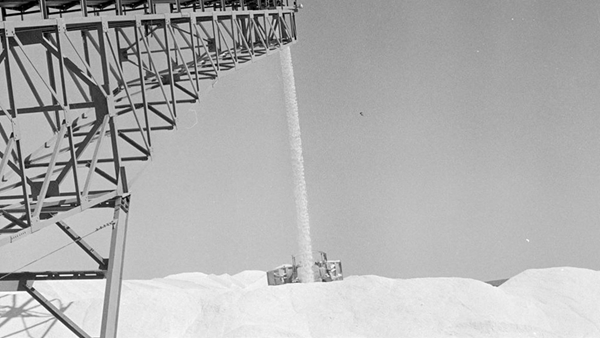Dry salt being stacked ready for loading on a ship at Mistaken Island in Dampier, 1972