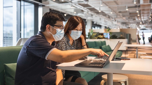 A vacation student working with her mentor at the Brisbane office practicing covid safety